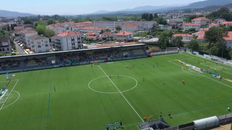 Football-players-training-on-grass-field-pitch-at-Ponte-de-Lima-stadium-Portugal