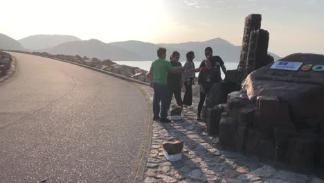 Chinese-tourists-take-photographs-at-the-East-Dam-in-Sai-Kung-East-Country-Park,-Hong-Kong