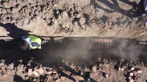 Aerial-drone-view-of-men-supplying-wires-and-digging-pits