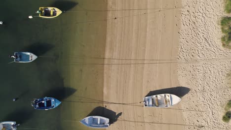 Moored-Boats-on-Alvor-Beach-at-low-tide,-Portugal-Aerial-top-View