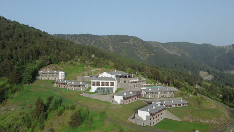 Hidden-within-the-wild-terrain-of-Epirus,-Grand-Forest-Metsovo-invites-guests-to-indulge-in-unparalleled-comfort-and-natural-beauty,-situated-on-a-private-mountain-amidst-a-pristine-black-pine-forest