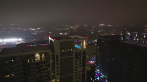 Aerial-view-around-the-Parkside-at-Discovery-Green-with-fireworks-in-the-background,-in-Houston