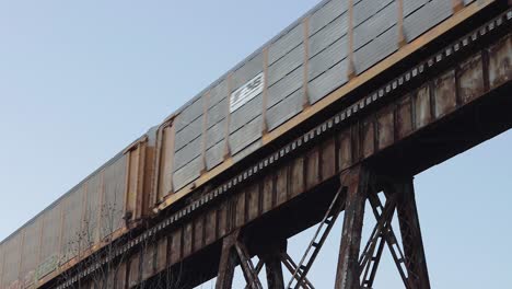 Auto-Carrier-Train-with-Norfolk-Southern-Engine-in-the-Middle-Crosses-the-Pope-Lick-Trestle-in-Louisville,-Kentucky-at-Sunset