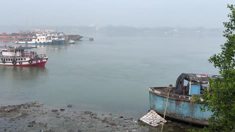 Static-shot-of-a-local-ferry-arriving-coast-of-Hooghly-river-in-Kolkata,-India