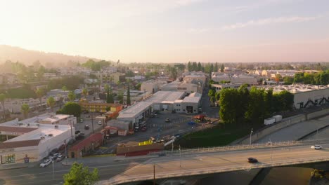 Flying-Over-Studio-City,-Drone-Footage-of-Roads-and-Businesses-with-Bright-Sunny-Sky-Ahead