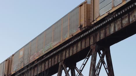 Auto-Carrier-Train-with-Norfolk-Southern-Engine-in-the-Middle-Crosses-the-Pope-Lick-Trestle-in-Louisville,-Kentucky-at-Sunset