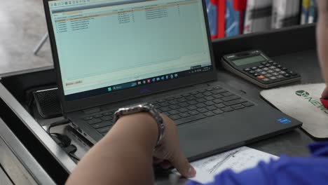 Latin-woman-working-writing-in-a-notebook-on-her-office-desk