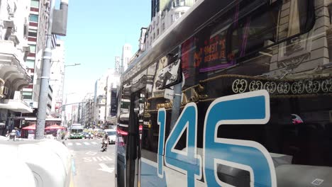 POV-Bus-Cars-and-Taxis-Drives-Through-Corrientes-Avenue-Famous-Downtown-Street-during-Summer-Morning-in-South-American-Vibrant-Capital