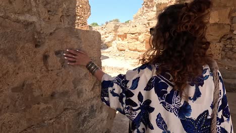 Follow-me-shot-of-women-in-traditional-clothes-in-the-ancient-city's-ruins-of-Carthage-in-Tunisia