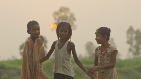 Group-of-happy-children-laughing-together-outdoor-during-sunset