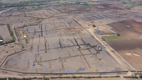 An-aerial-drone-view-of-the-fitting-is-still-to-be-done-and-large-solar-system-boxes-are-visible-around-and-large-wires-are-also-visible