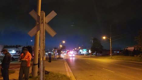 Firetruck-rushing-towards-the-direction-of-a-huge-inferno,-passing-by-photographers-armed-with-cameras-and-tripods-taking-footages-and-pictures-of-an-ongoing-disaster-in-Toronto,-Canada