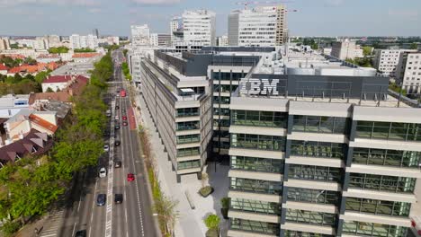 Aerial-drone-view-of-IBM-logo-against-blue-sky-on-the-top-of-modern-business-building-on-sunny-day