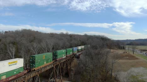 Aerial-Shot-Pulling-Back-from-an-Intermodal-Train-Crossing-the-Pope-Lick-Trestle-in-Louisville,-Kentucky-on-a-Sunny-Winter-Day