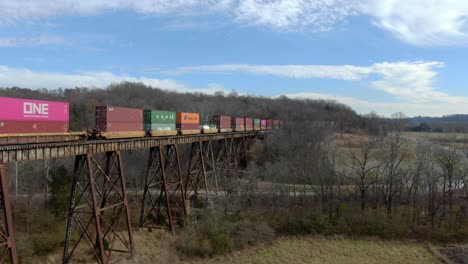 Aerial-Shot-of-an-Intermodal-Freight-Train-Crossing-the-Pope-Lick-Trestle-in-Louisville-Kentucky-in-the-Winter