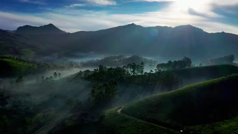 Aerial-drone-view-A-four-wheeler-is-driving-down-the-road-in-the-drone-camera-and-big-hills-are-visible-and-big-trees-are-also-visible-around