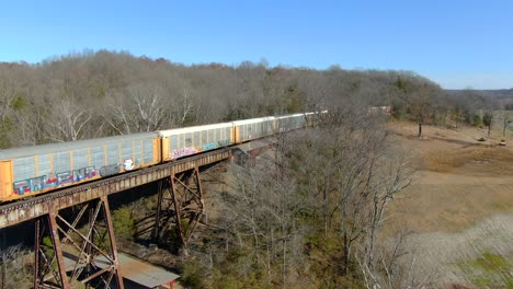 Toma-Aérea-De-Un-Tren-De-Transporte-De-Automóviles-Que-Se-Dirige-Al-Caballete-Pope-Lick-En-Louisville,-Kentucky,-En-Un-Soleado-Día-De-Invierno