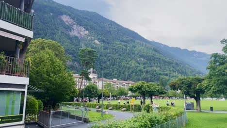 Blogger-and-Couple-Holding-Hands-At-Outdoor-Concert-|-Interlaken-Switzerland-Immersive-Travel-Tourism-Mountainside-Valley-Resort-City,-Europe,-Walking,-Rainy-Day,-4K