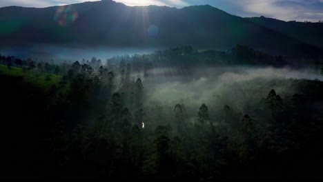 Aerial-dron-view-going-forward-where-lots-of-big-mountains-and-greenery-on-hills-has-been