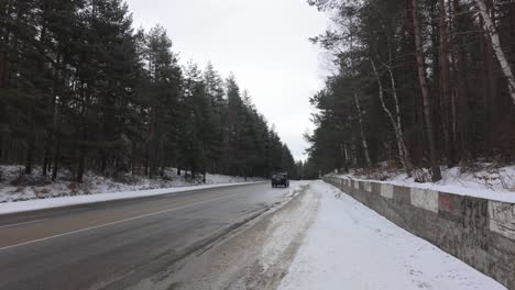 SUV-driving-on-a-wet,-snowy-road-in-the-winter-in-sub-zero-temperatures-and-the-possibility-of-the-road-freezing