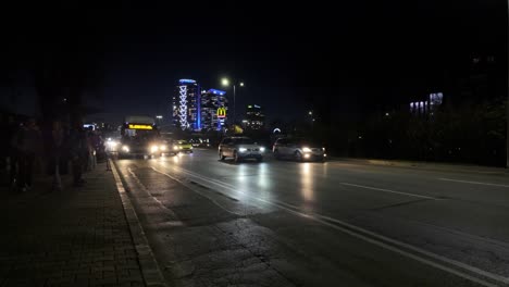 Public-Bus-72-arriving-to-a-bus-stop-at-'Evlogi-and-Hristo-Georgievi-Boulevard'-at-night-and-people-preparing-to-get-on