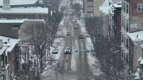 Aerial-descending-shot-with-snow-flurries-falling