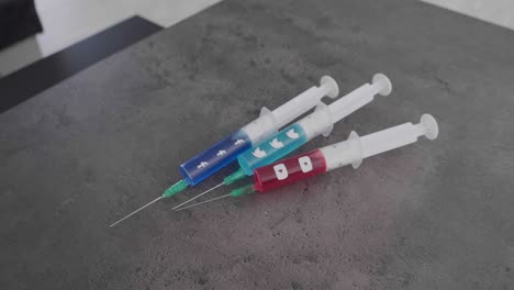 several-syringes-filled-with-colorful-liquid-symbolizing-social-media-addiction-and-the-Snapchat-Symbol-being-picked-up