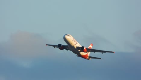 Air-Canada-Rouge-plane-flying-overhead-with-blue-sky-and-white-Clouds-in-the-background-in-Ontario,-Canada-at-daytime