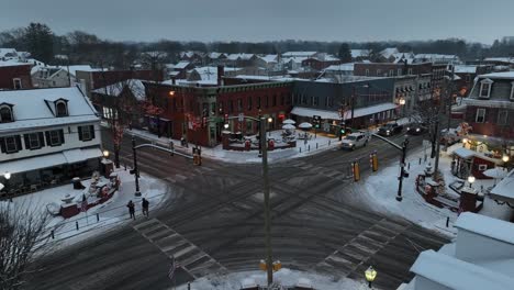 Small-town-square-with-snow-and-Christmas-decorations-on-cold-December-night