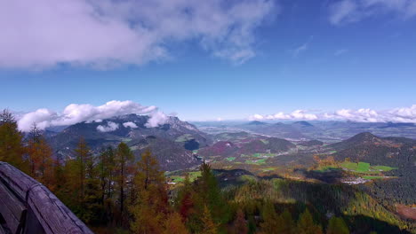 Beautiful-mountain-landscape-below-blue-sky,-people-enjoying-view