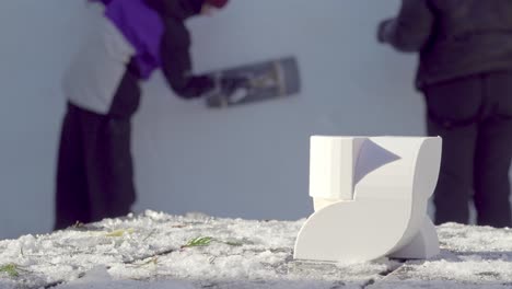 Austrian-HTL-students-work-on-their-snow-sculpture,-Synergy,-during-the-33rd-Dolomites-Snow-Festival-in-Innichen---San-Candido,-South-Tyrol,-Italy