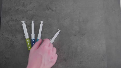 several-syringes-filled-with-colorful-liquid-symbolizing-social-media-addiction-with-the-twitter-symbol-being-picked-up