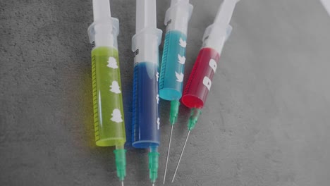 several-syringes-filled-with-colorful-liquid-symbolizing-social-media-addiction-and-the-Snapchat-Symbol-being-picked-up