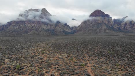 Aerial-drone-shot-of-mountains-with-low-clouds