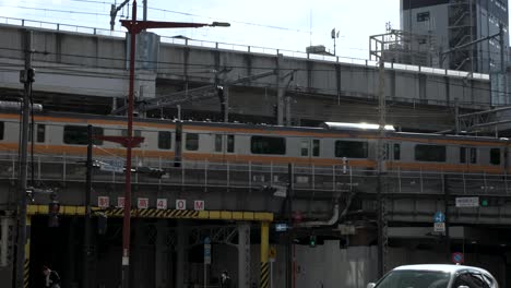 Chuo-Metro-Line-Train-Going-Past-On-Elevated-Tracks-In-Tokyo