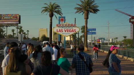 Tourists-In-Front-Of-Welcome-to-Fabulous-Las-Vegas-sign-on-a-bright-sunny-day
