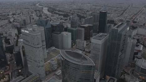 Aerial-drone-shot-of-the-modern-La-Defense-business-district-in-Paris,-France-in-the-early-morning-on-a-cloudy-day