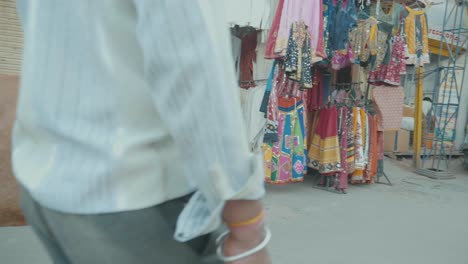 Large-Brown-White-Cow-Walking-Down-A-Crowded-Market-Street-In-India