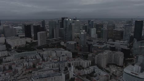 Aerial-drone-shot-of-the-modern-La-Defense-business-district-in-Paris,-France-in-the-early-morning-on-a-cloudy-day