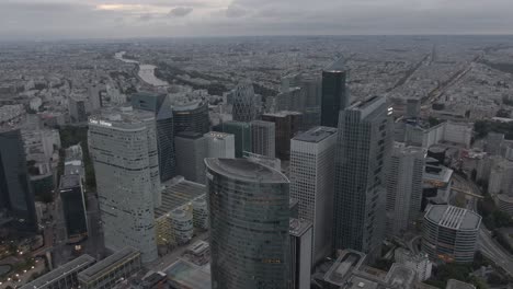 Aerial-drone-shot-of-the-modern-La-Defense-business-district-in-Paris,-France-in-the-early-morning-on-a-cloudy-day