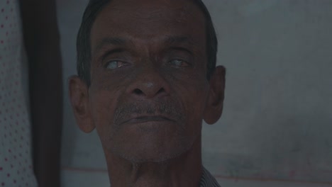 a-blind-and-disabled-old-man-looking-straight-into-the-camera-in-sri-lanka-symbolizing-the-bad-medical-supply-situation-in-developing-countries