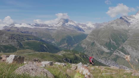 a-lonely-female-hiker-in-front-of-the-Matterhorn-mountain-in-Switzerland