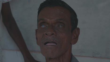 a-blind-and-disabled-old-man-looking-straight-into-the-camera-in-sri-lanka-symbolizing-the-bad-medical-supply-situation-in-developing-countries