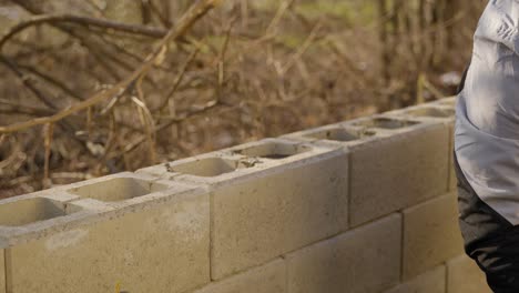 Worker-Pouring-Wet-Concrete-Or-Cement-On-Wall-In-Construction