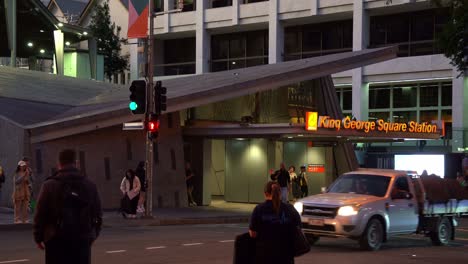 Buses-and-cars-moving-on-the-road-with-large-crowds-of-commuters-waiting-at-the-traffic-lights-on-Albert-and-Adelaide-street-in-Brisbane-city-towards-King-George-Square-busway-station,-close-up-shot