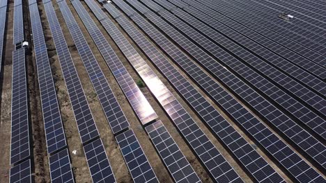 Aerial-drone-view-moving-to-the-side-in-phone-camera-showing-lots-of-big-solar-farms-and-sun-rays-falling