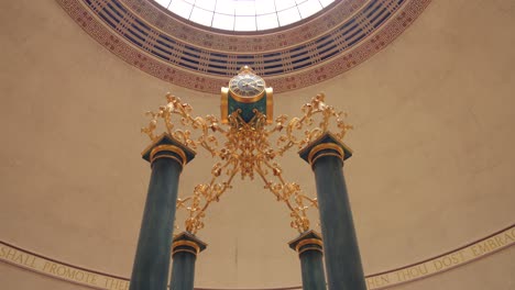 Detail-of-overhead-clock-in-the-Wolfson-Reading-Room-at-the-Central-Library-in-the-city-of-Manchester,-England