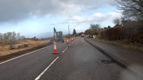 Van-and-machinery-at-roadworks-on-Skye-Island,-Scotland-under-cloudy-skies