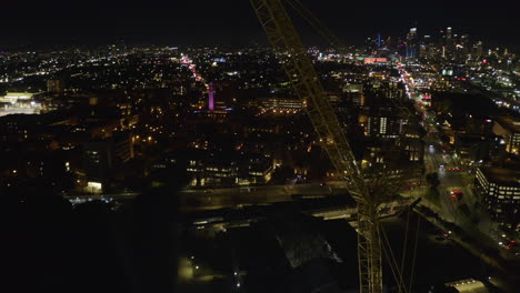 Aerial-view-of-the-Los-Angeles-skyline-and-a-Space-shuttle,-night-at-a-the-California-Science-Center