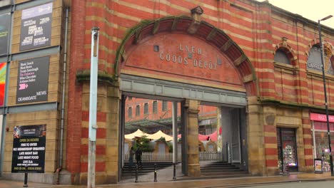 Profile-view-of-the-architecture-of-entrance-of-Great-Northern-Warehouse-with-text-LNER-Goods-Depot-during-daytime-in-Manchester,-England